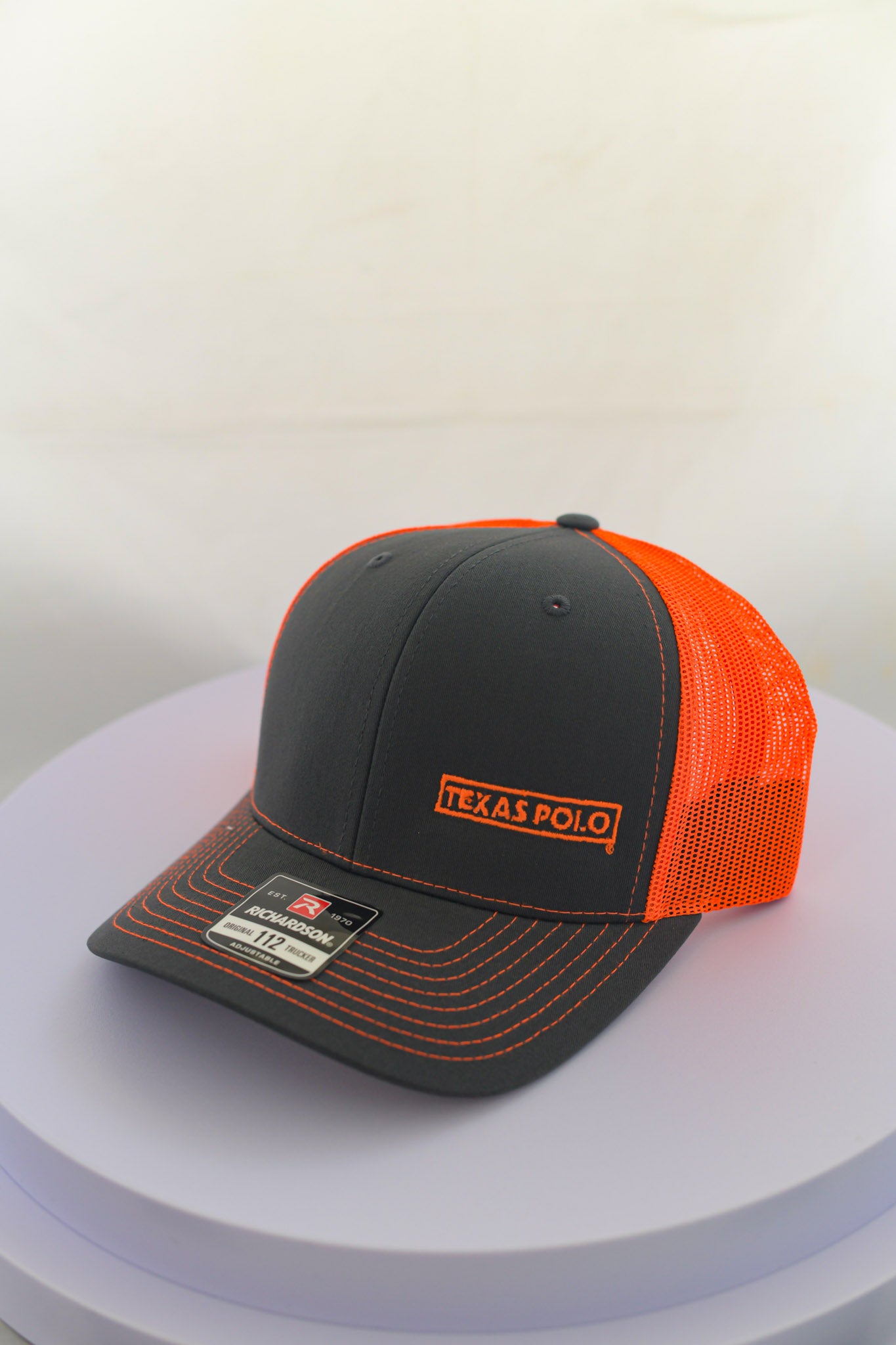 Grey and orange mesh back cap with small orange Texas Polo logo.