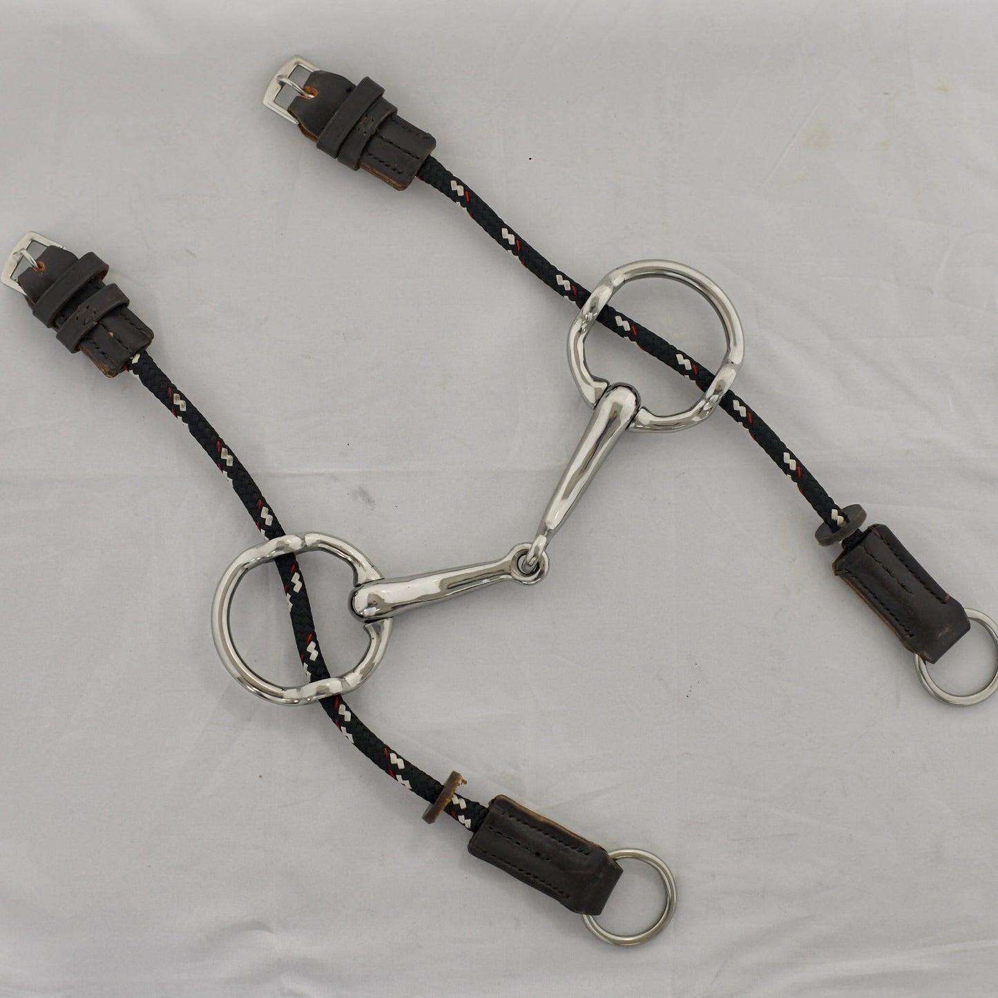 4 inch ring gag horse bit on a white surface.
