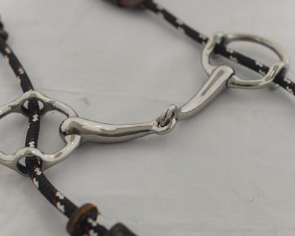Close up of a 4 inch ring gag horse bit on a white surface.