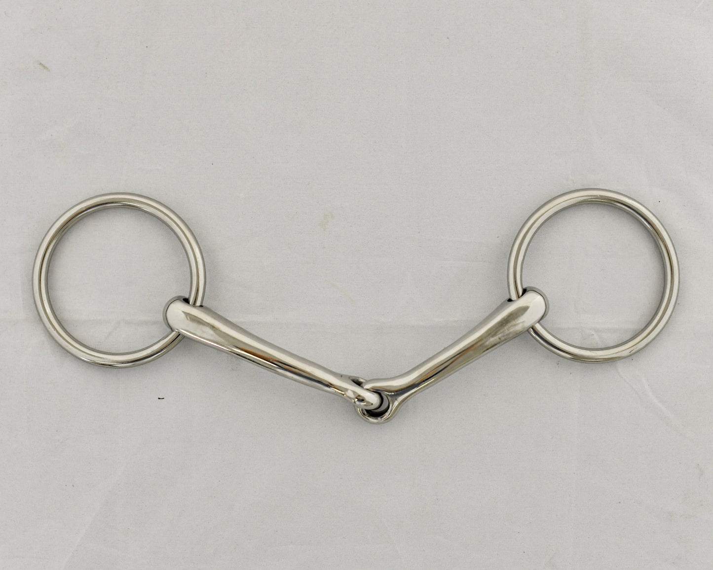 Badroon gag horse bit on a white surface.