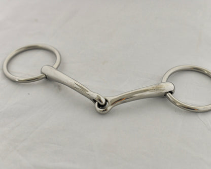 Close up of badroon gag horse bit on a white surface.