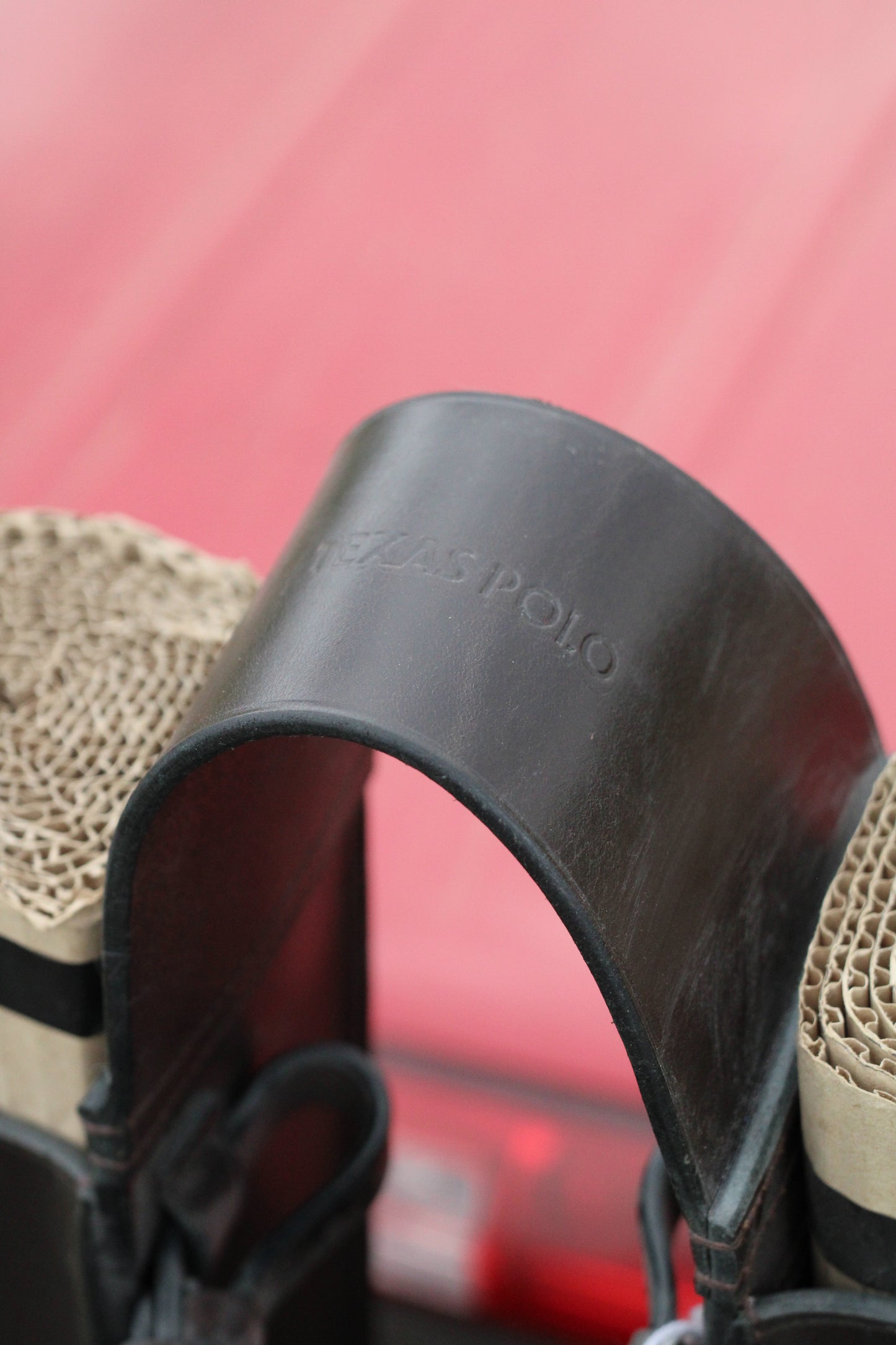 Top view of leather ball holder with Texas Polo branding.