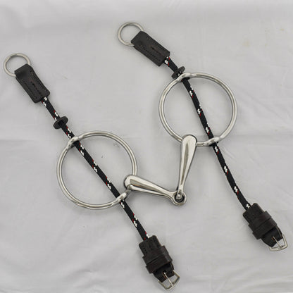 Big ring gag horse bit on a white surface.
