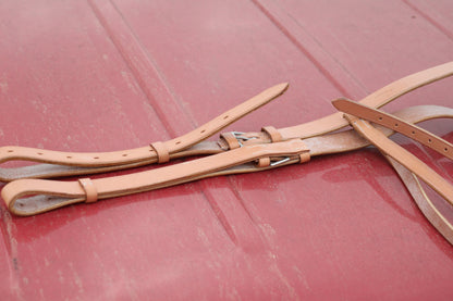 Leather breastplate sitting on a red surface.
