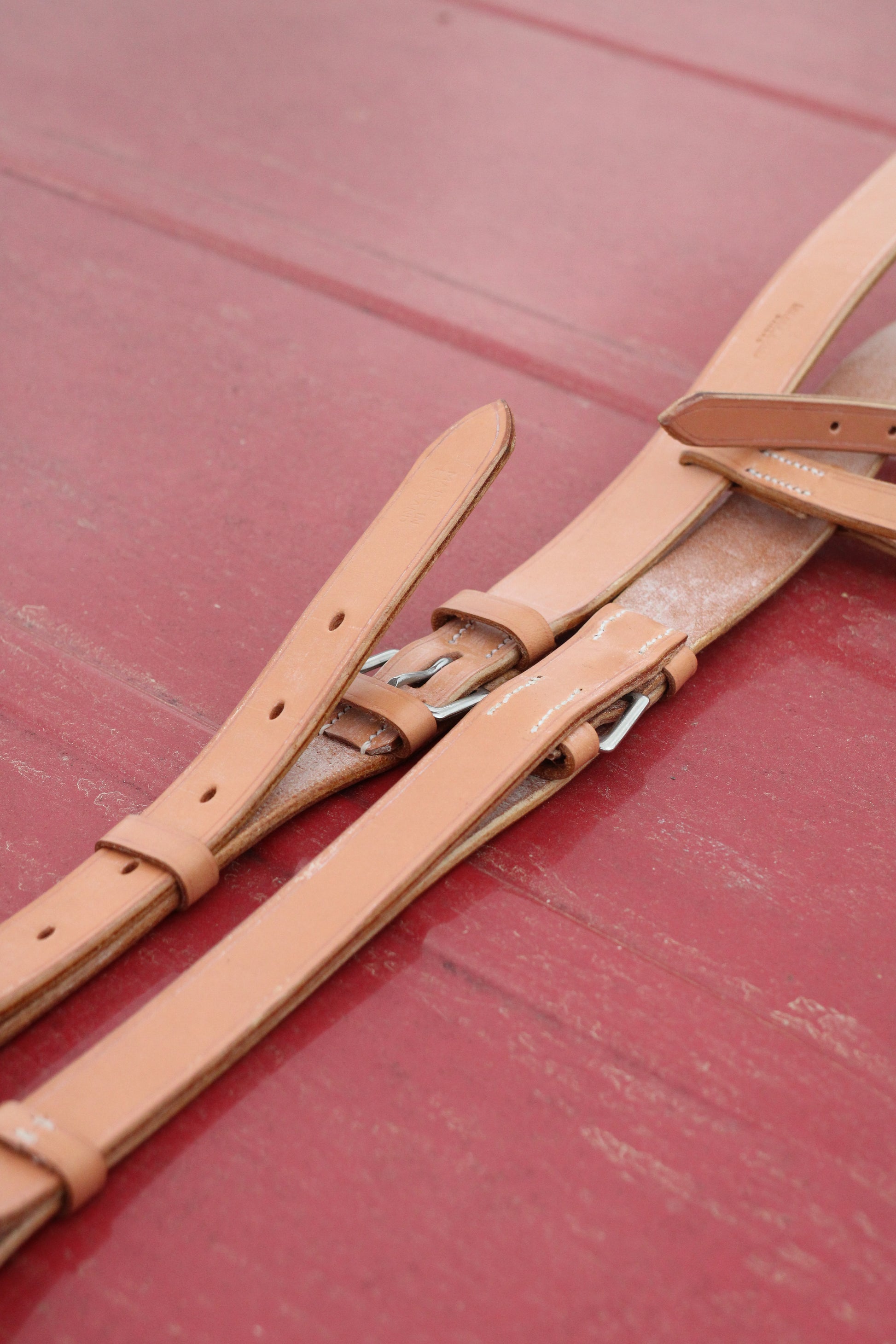 Leather breastplate sitting on a red surface.