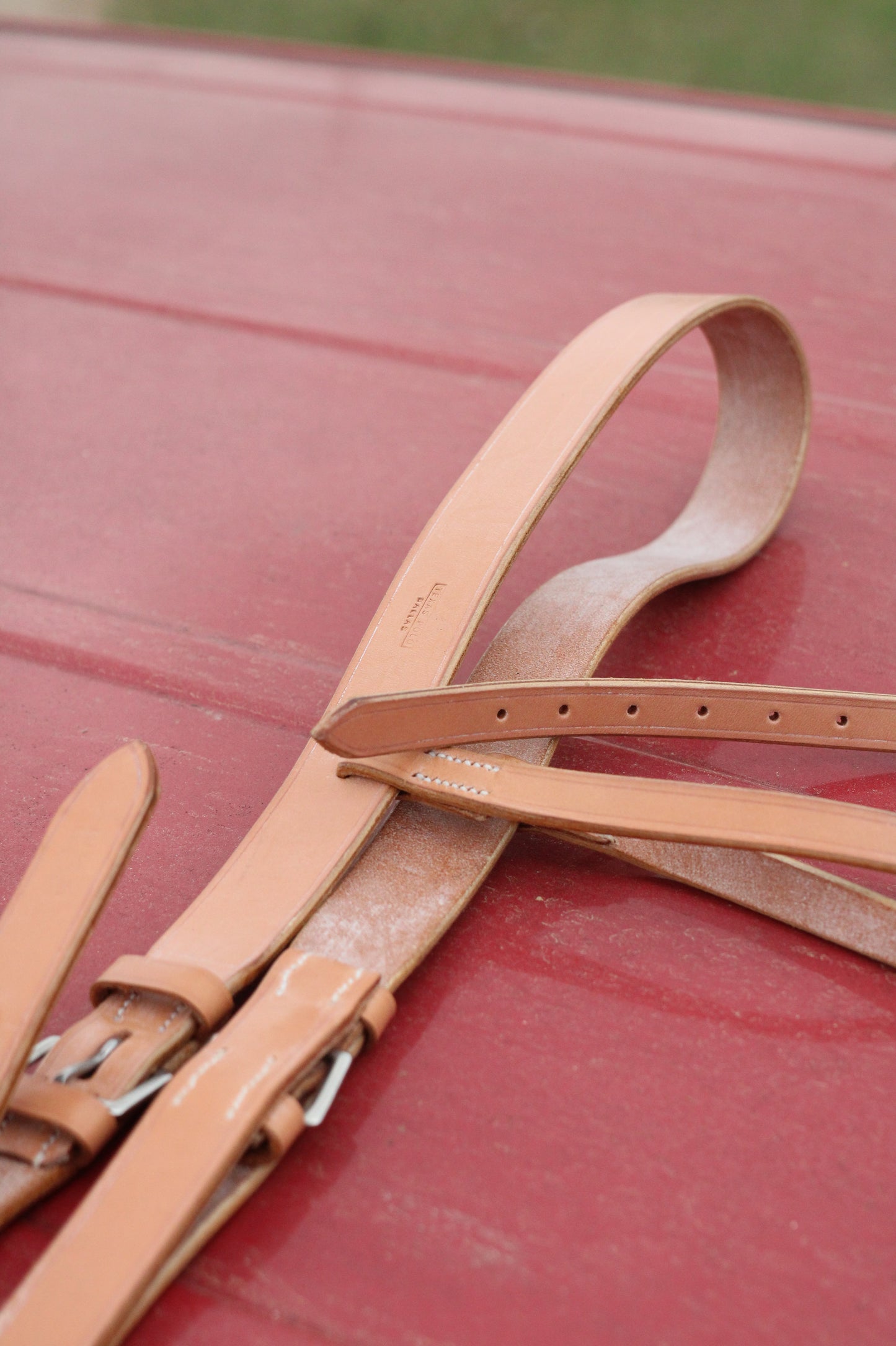 Leather breastplate sitting on a red surface.