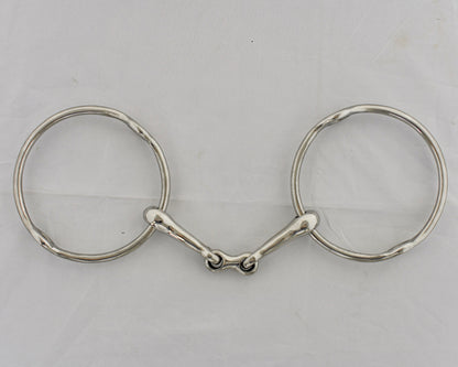 Center link gag horse bit on a white surface.