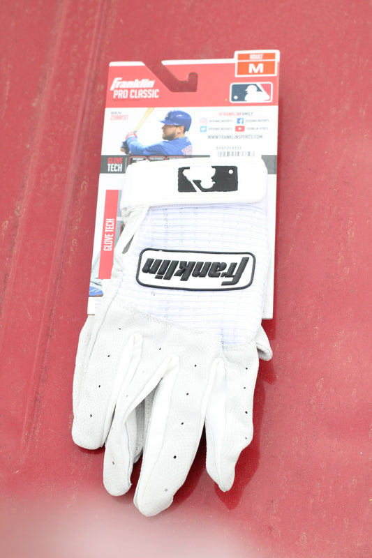 Pair of white athletic gloves sitting on a red surface.
