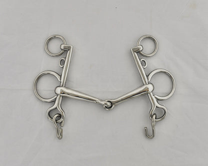 Jointed pelham horse bit on a white surface.