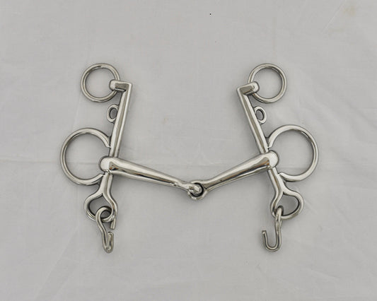 Jointed pelham horse bit on a white surface.