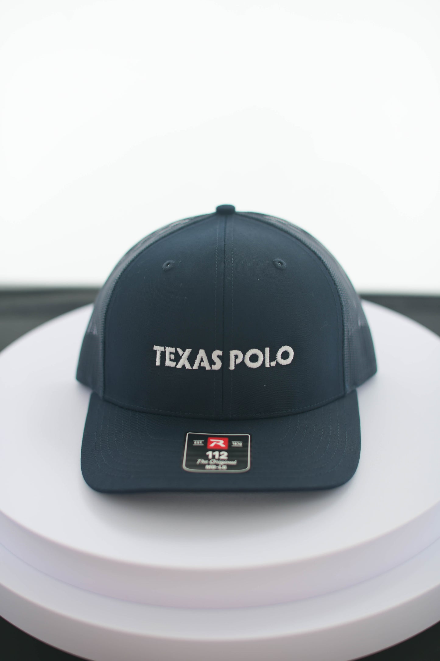 Navy Texas Polo cap on a white surface.
