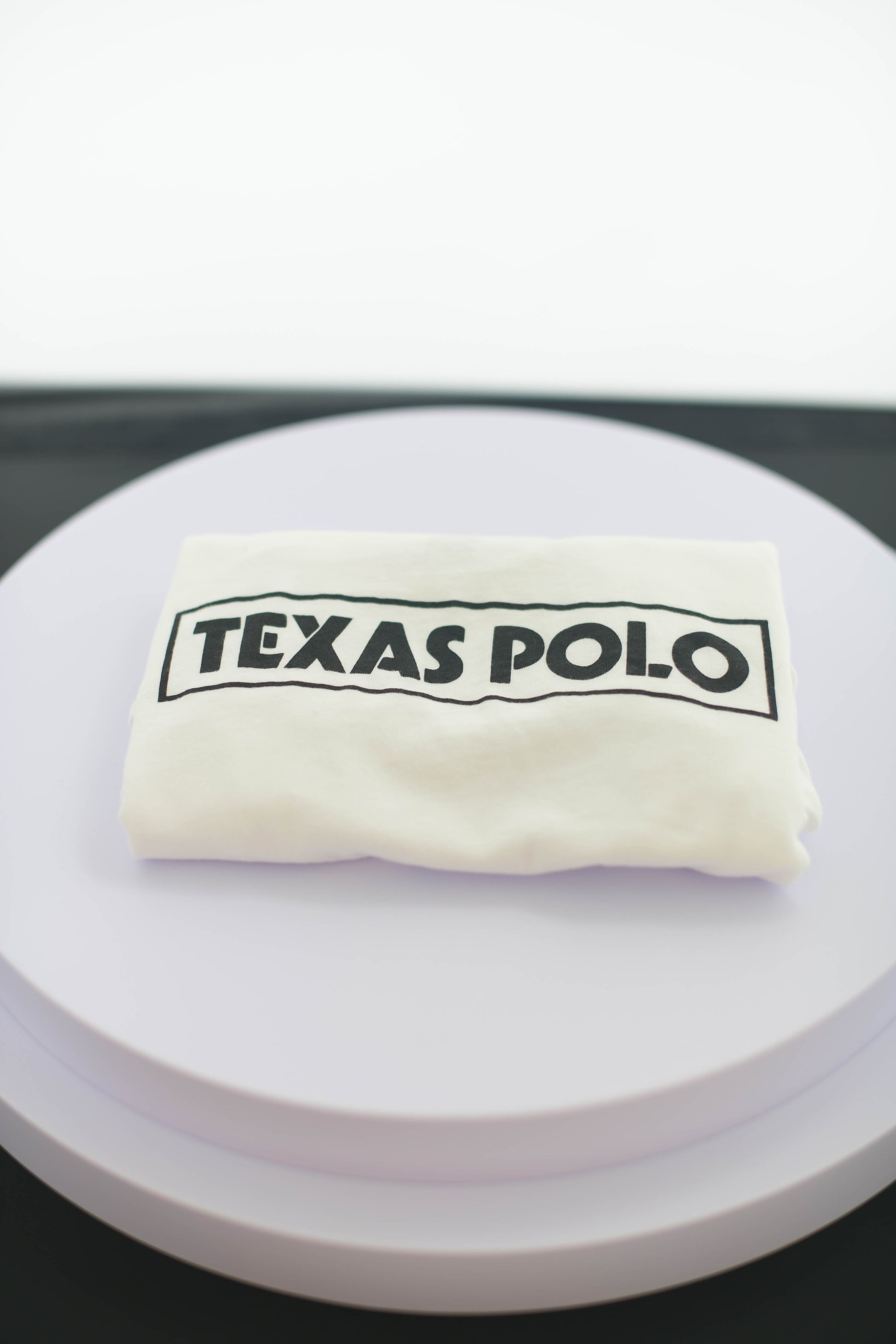 Folded white Texas Polo t-shirt.