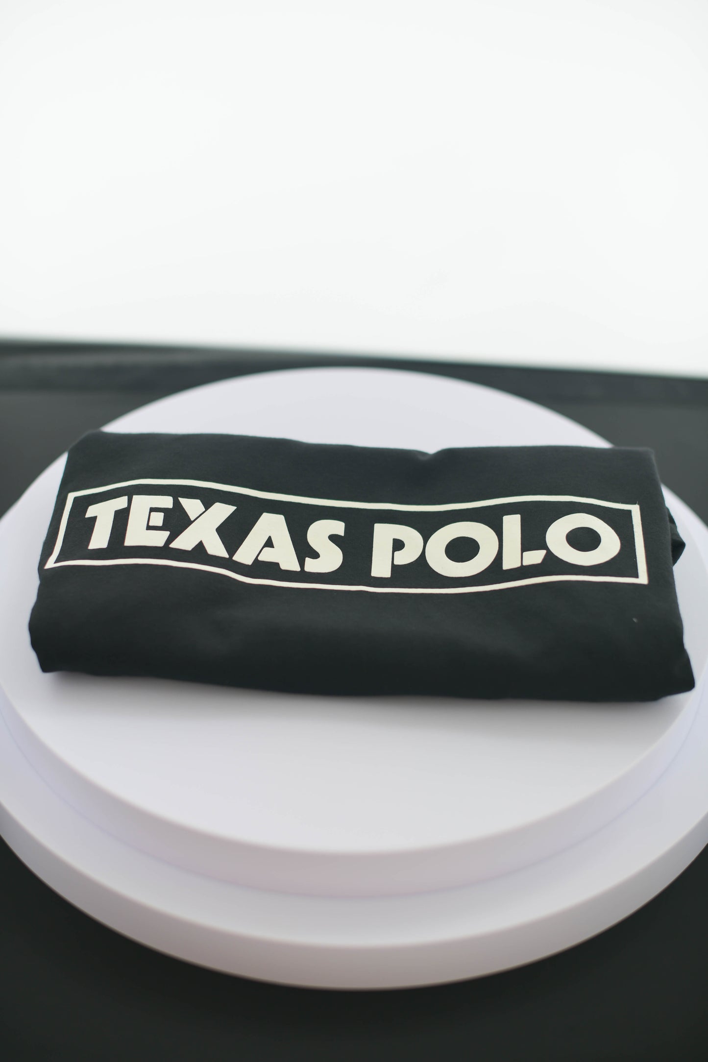 Folded black Texas Polo tshirt.