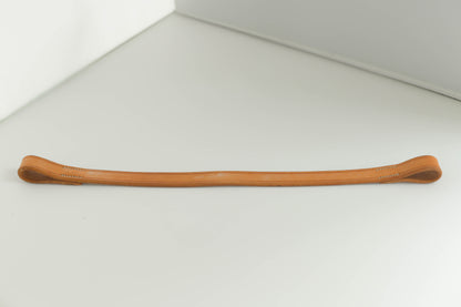 Leather brow band on a white surface.
