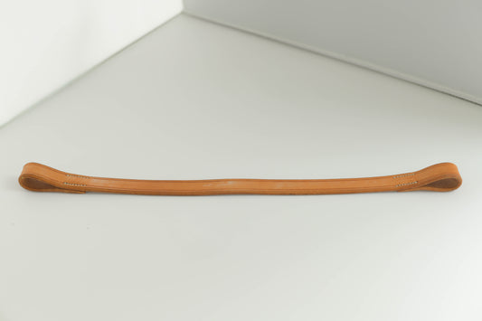 Leather brow band on a white surface.