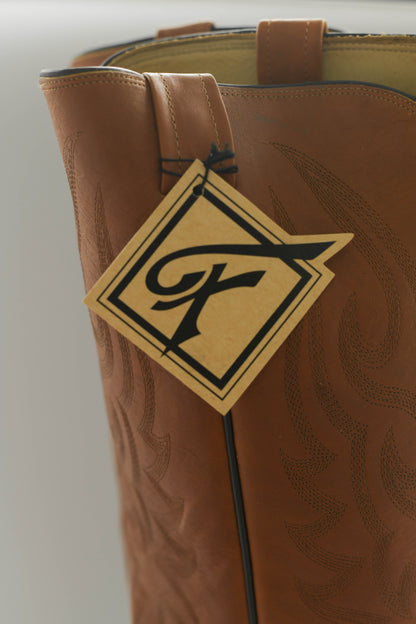 Closeup of the tag on a brown leather boot.