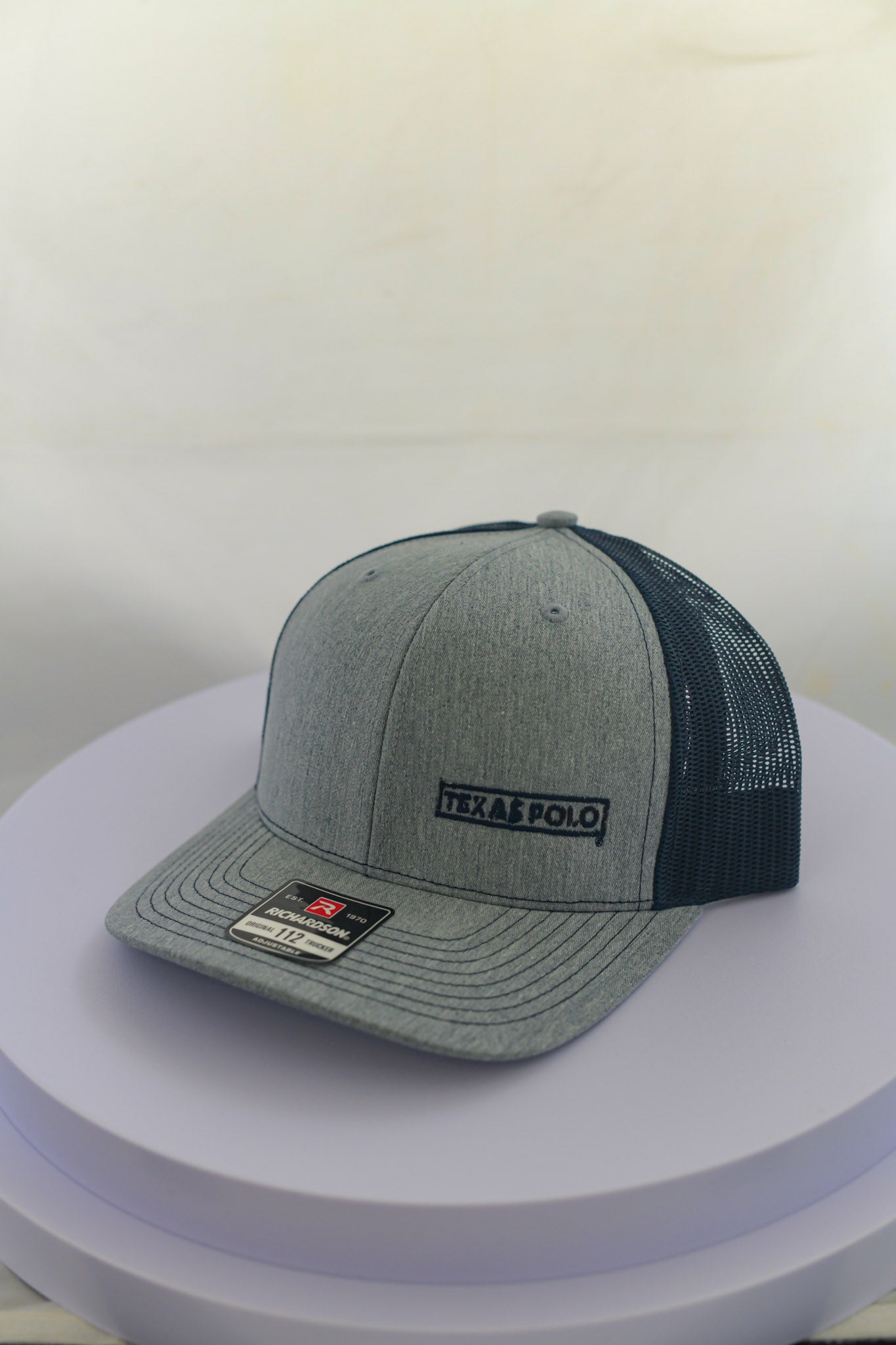 Grey and navy mesh back cap with small navy Texas Polo logo.