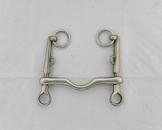 Pelham horse bit on a white surface.