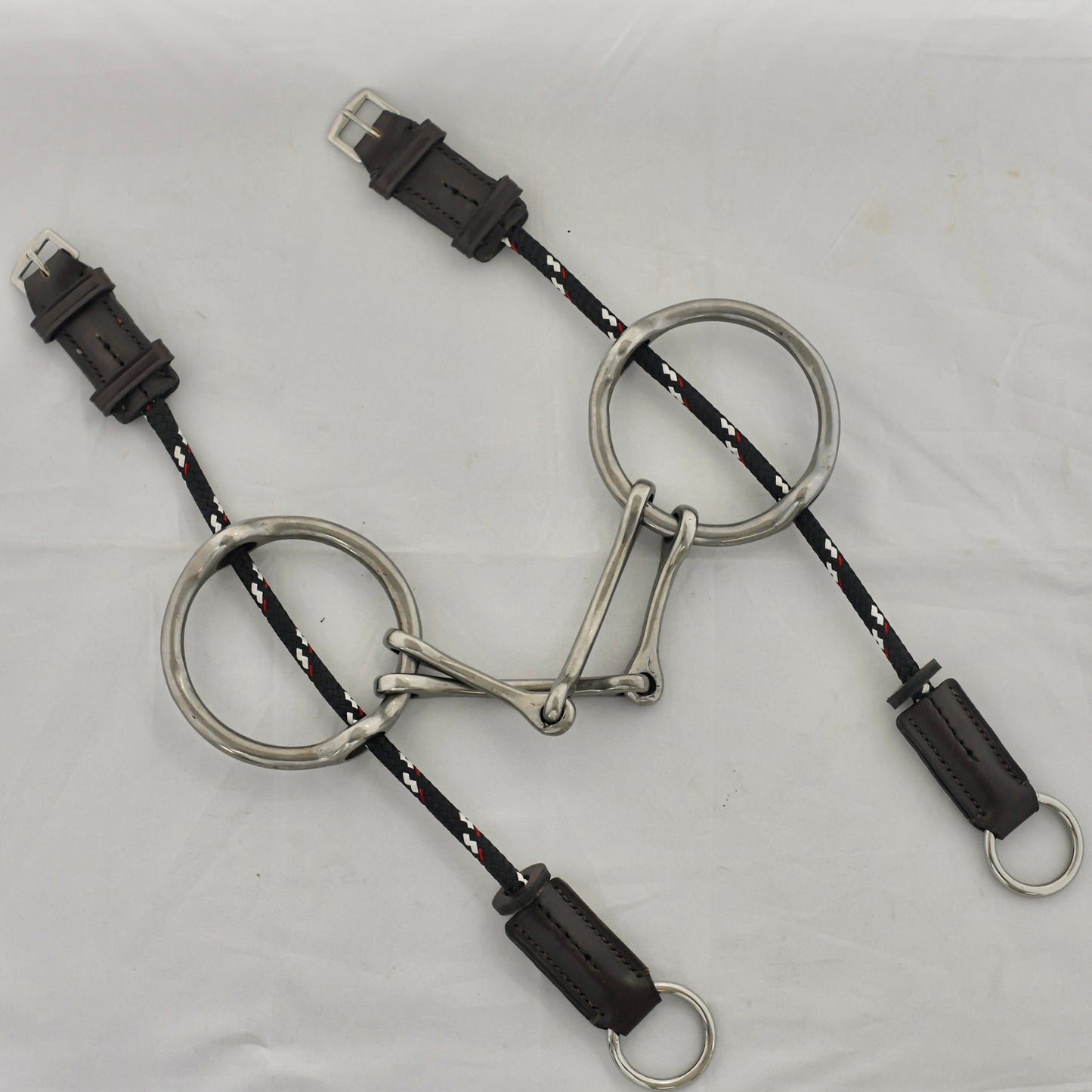 Plain barry gag horse bit on a white surface.