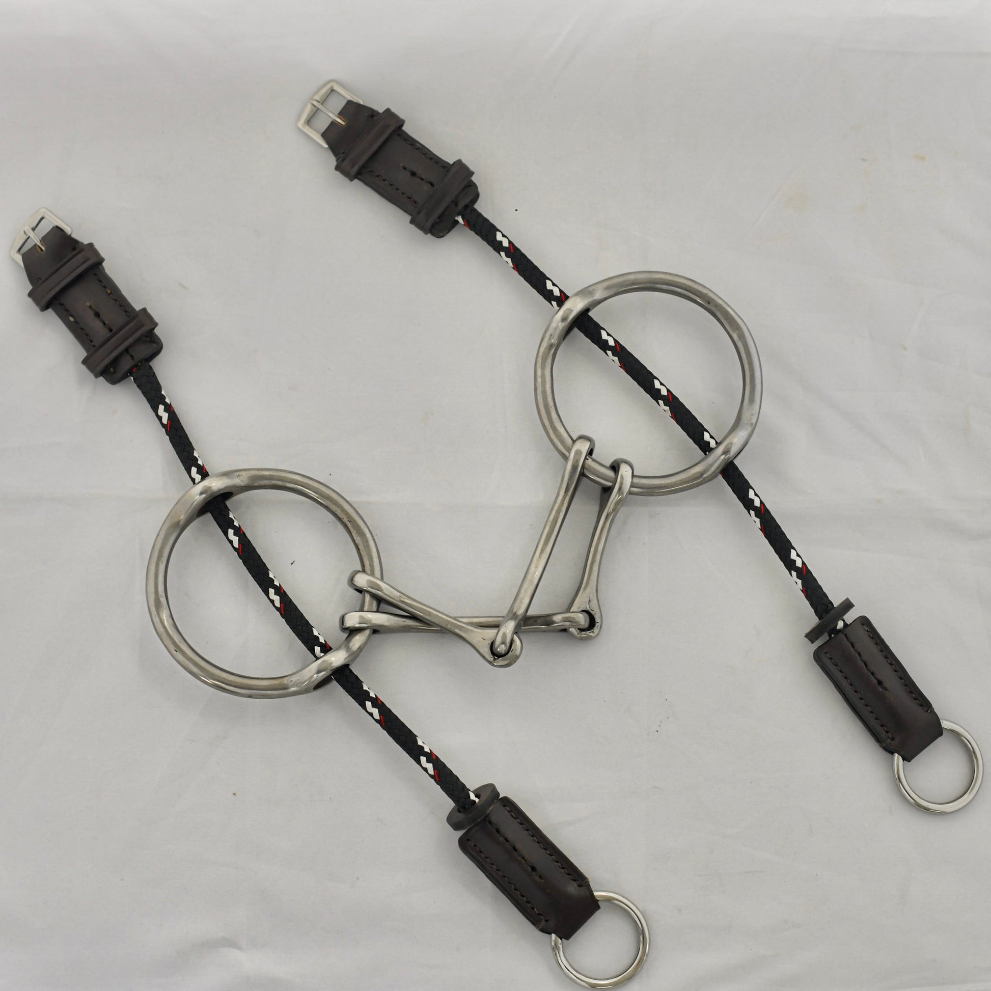 Plain barry gag horse bit on a white surface.