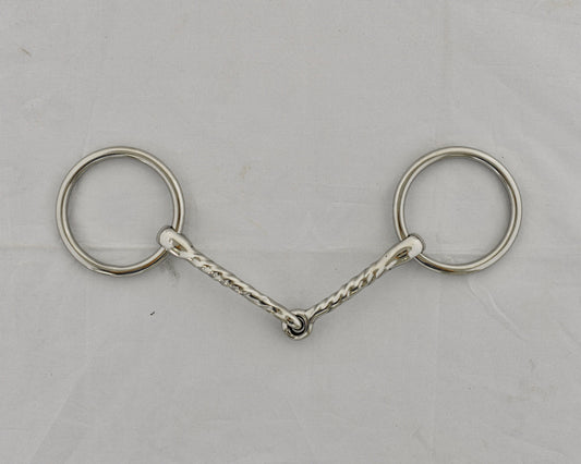 Twisted badroon gag horse bit on a white surface.