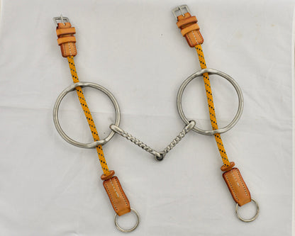 Twisted big ring gag horse bit on a white surface.