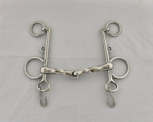 Twisted jointed pelham horse bit on a white surface.