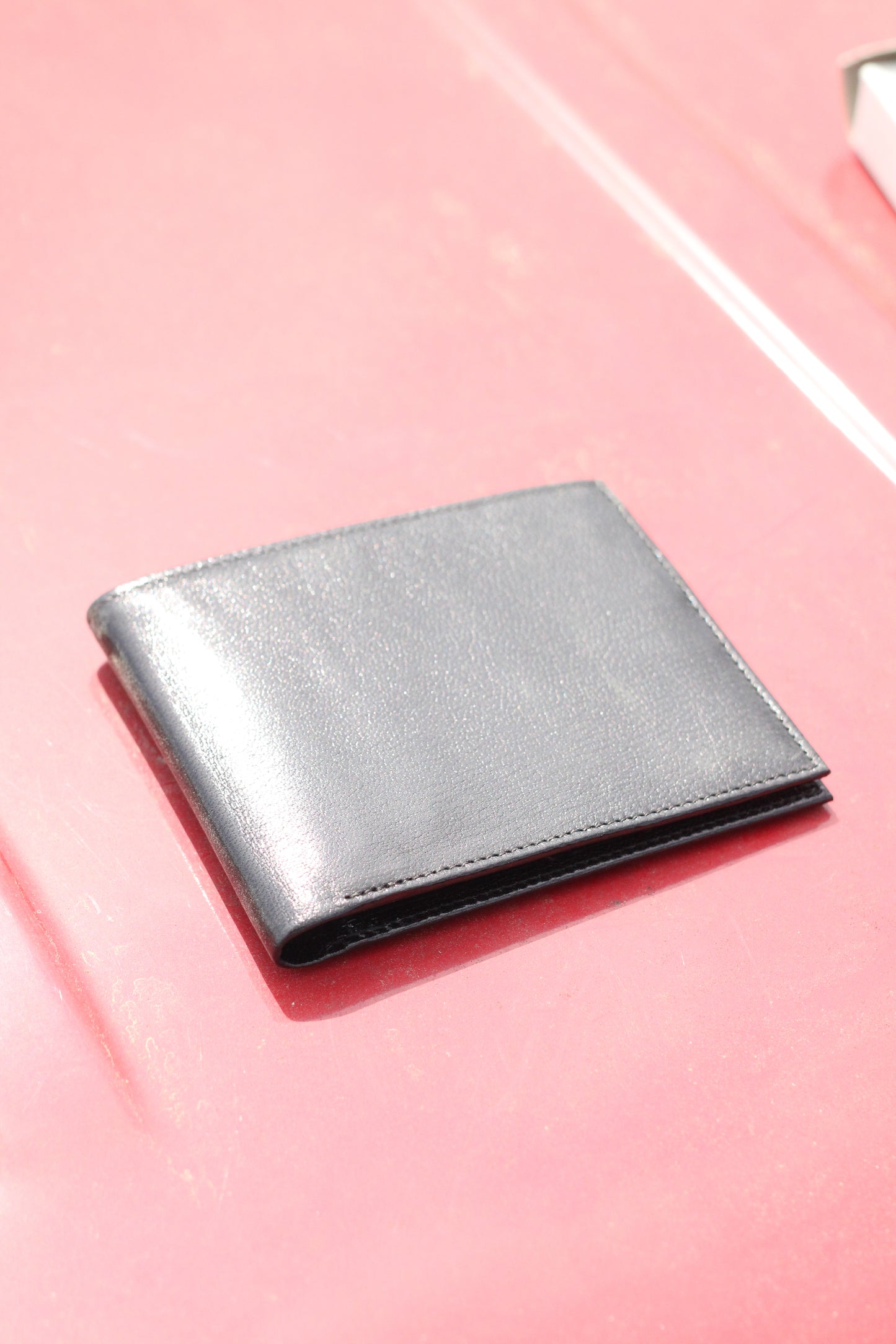 Closed leather bifold wallet.