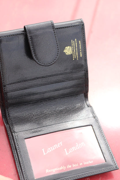 Leather bifold wallet with small snap closure opened face up.